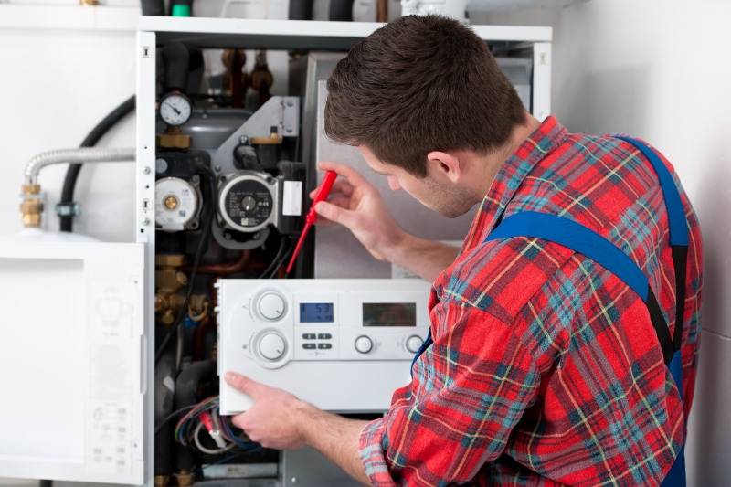 Gas Safe engineer working on a boiler in Enfield